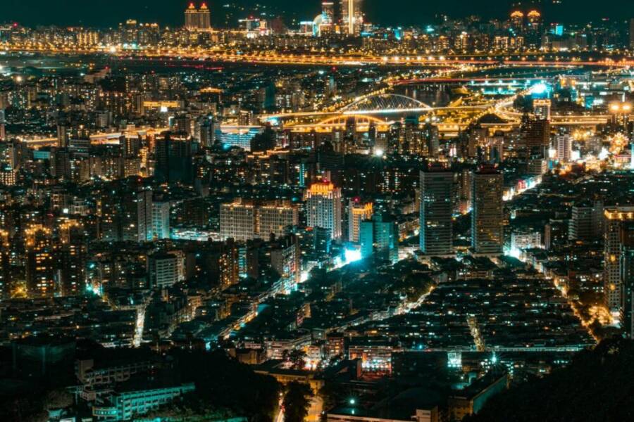 Breathtaking nighttime aerial view of Taipei's vibrant city lights and skyline.
