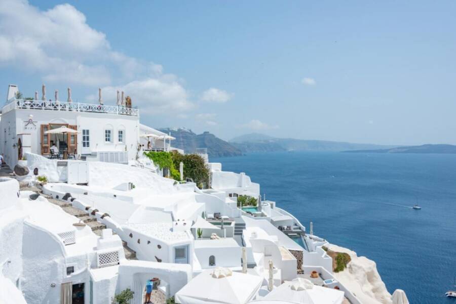 Santorini's iconic white buildings and blue sea create a perfect summer scene ideal for travel enthusiasts.