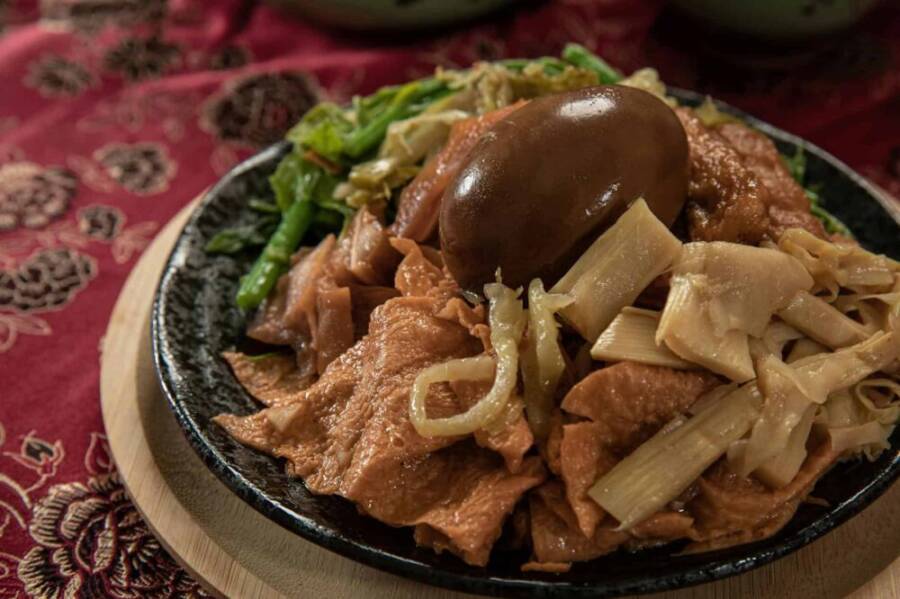 A savory dish featuring traditional Taiwanese street food with a marinated egg and vegetables, perfect for food enthusiasts.