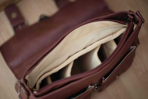 Detailed look inside an elegant brown leather briefcase with organized compartments.