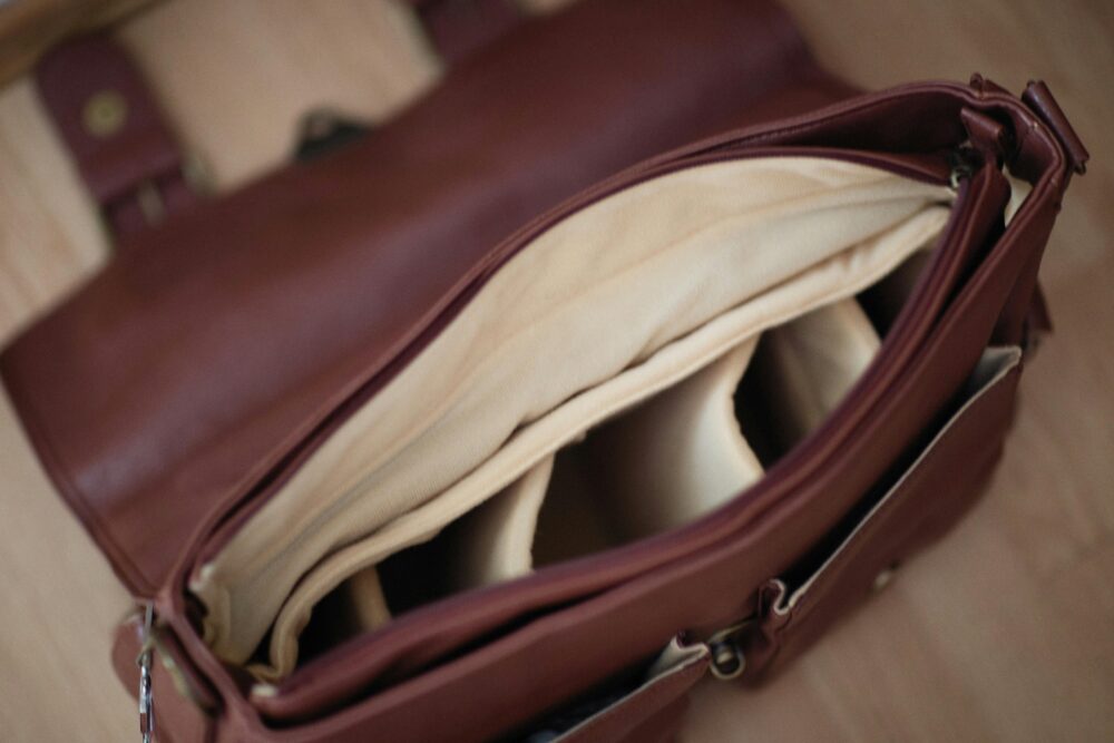 Detailed look inside an elegant brown leather briefcase with organized compartments.