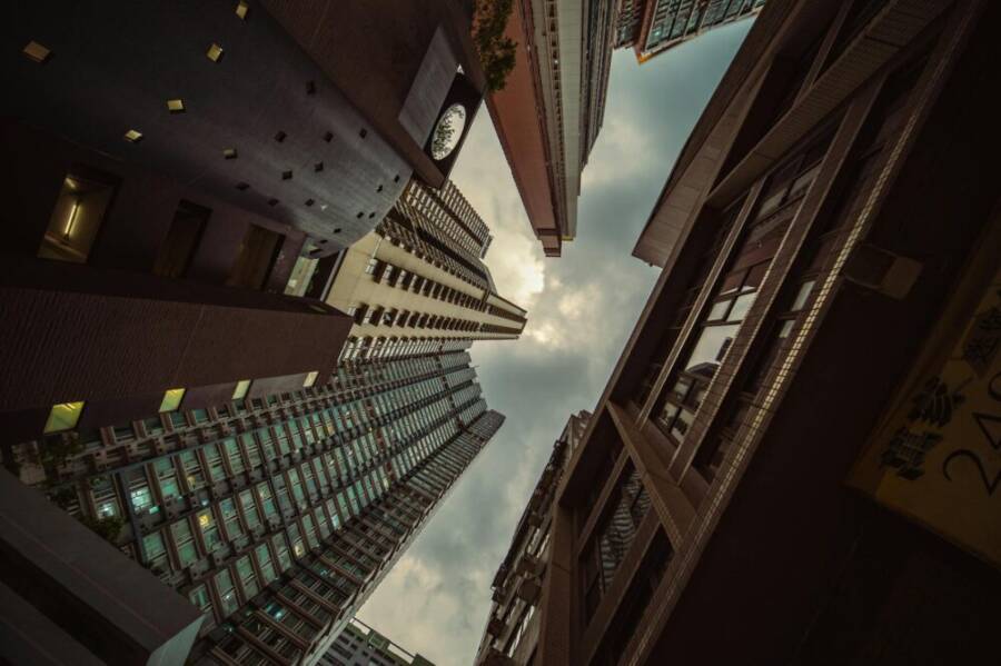 Low angle shot of Hong Kong skyscrapers creating a striking architectural perspective.