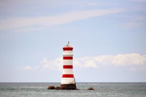 Iconic Rangitoto lighthouse standing tall against the ocean backdrop in Auckland, New Zealand.