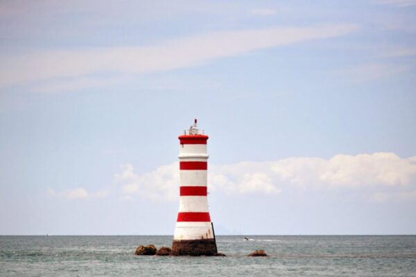 Iconic Rangitoto lighthouse standing tall against the ocean backdrop in Auckland, New Zealand.