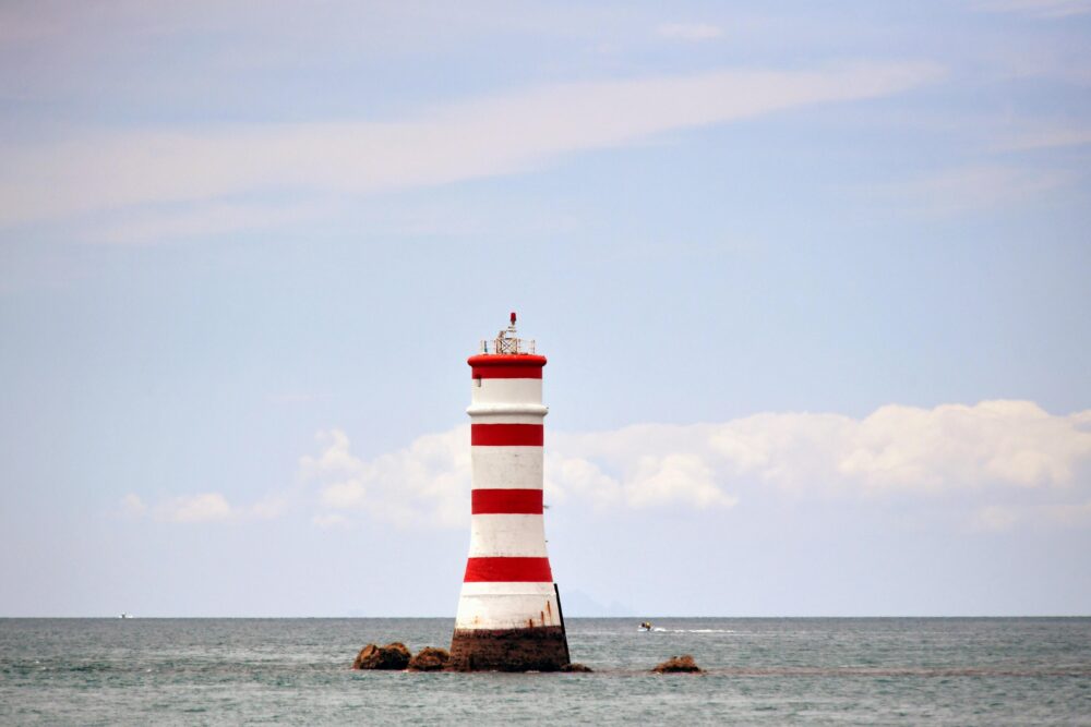 Iconic Rangitoto lighthouse standing tall against the ocean backdrop in Auckland, New Zealand.