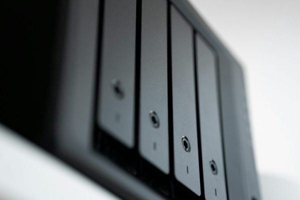 NAS 行動裝置備份入門:Synology 群暉簡單指南 Detailed view of a black data storage unit highlighting modern technology and data management.