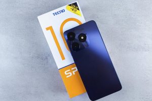 Blue smartphone on gray background. Featuring 128GB storage, displayed with its packaging. Modern technology focus.