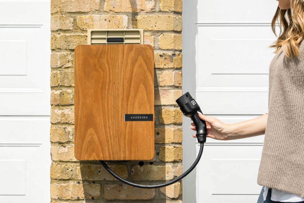 Wooden EV home charger installed on a brick wall for sustainable transportation