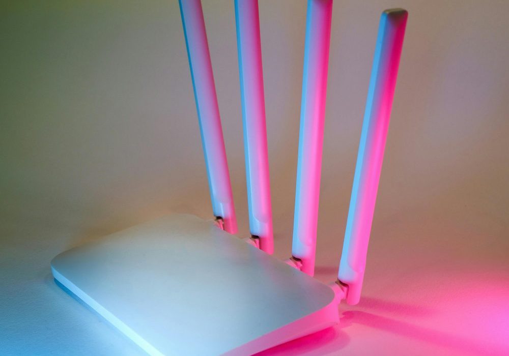 A sleek wireless router enhanced by vibrant neon lights, showcasing cutting-edge technology.