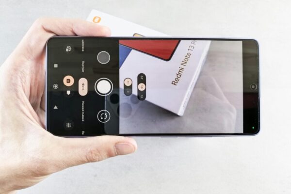 Close-up of a smartphone camera app focusing on a Redmi Note 13 Pro box.