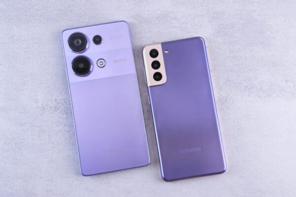 Detailed image showcasing two purple smartphones on a light surface