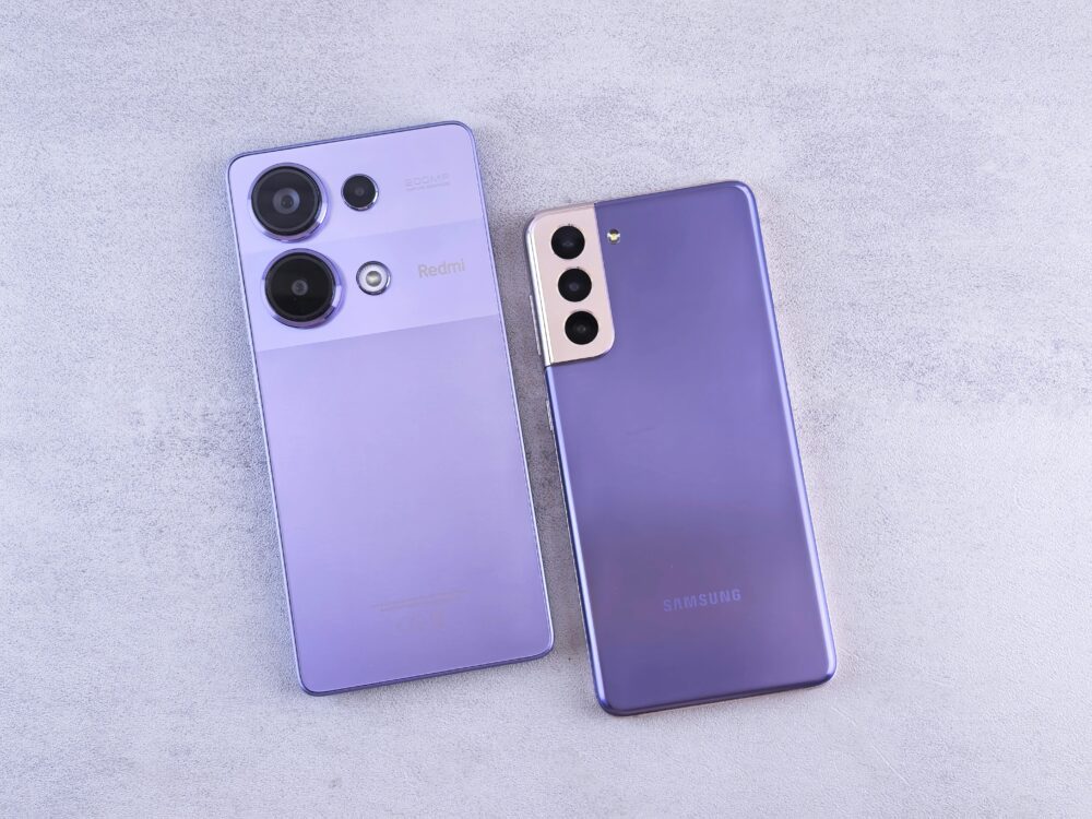 Detailed image showcasing two purple smartphones on a light surface