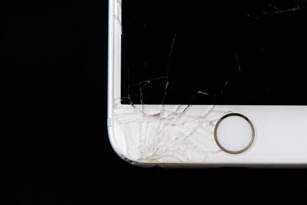 Detailed image of a cracked smartphone screen highlighting damage to the device.