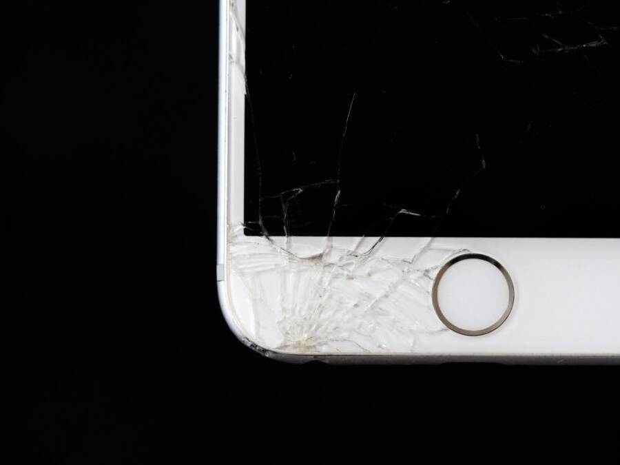 Detailed image of a cracked smartphone screen highlighting damage to the device.