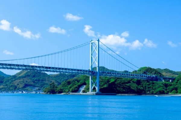Scenic view of a suspension bridge spanning the Seto Inland Sea in bright daylight