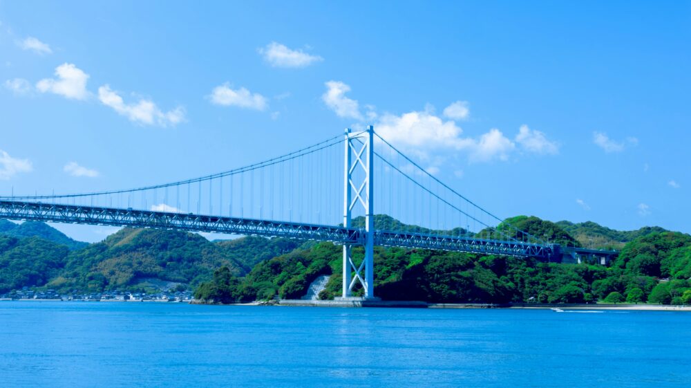 Scenic view of a suspension bridge spanning the Seto Inland Sea in bright daylight