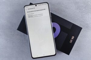 A smartphone on a box showing a software update screen, creating a tech-focused scene