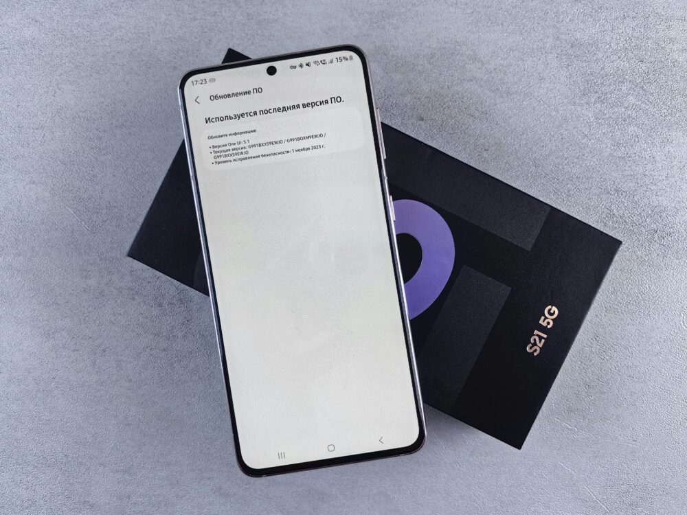 A smartphone on a box showing a software update screen, creating a tech-focused scene