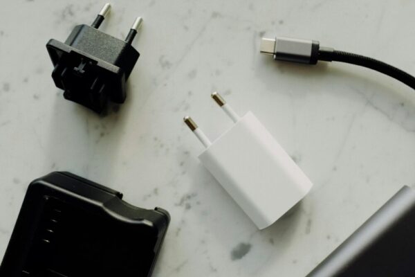Collection of power adapters and a USB-C charging cable on a marble surface