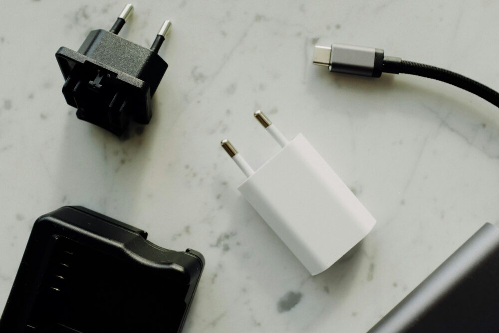 Collection of power adapters and a USB-C charging cable on a marble surface
