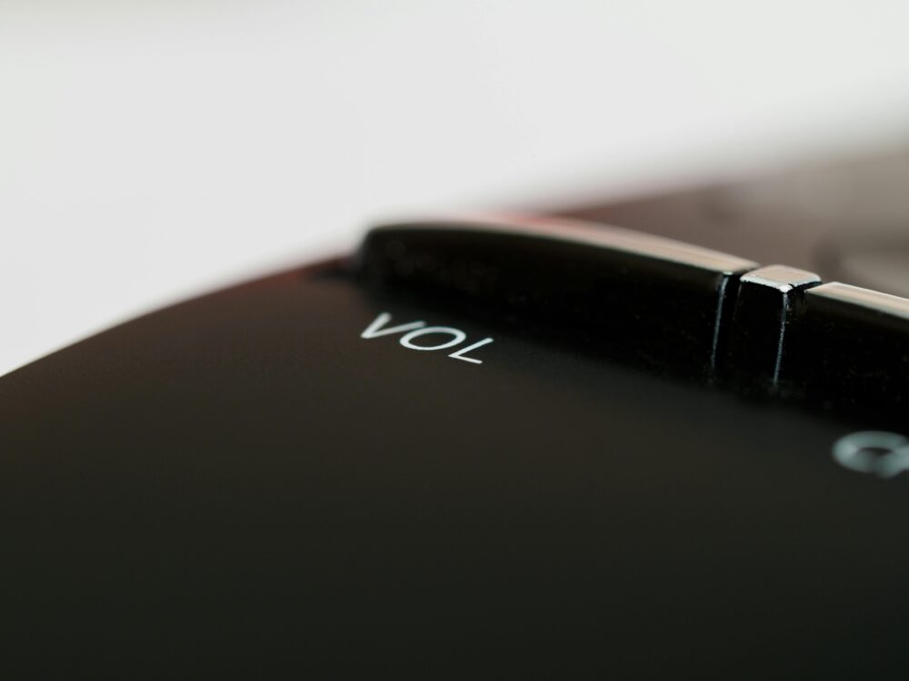 Extreme close-up view of a volume button on an electronic device, highlighting details and texture.