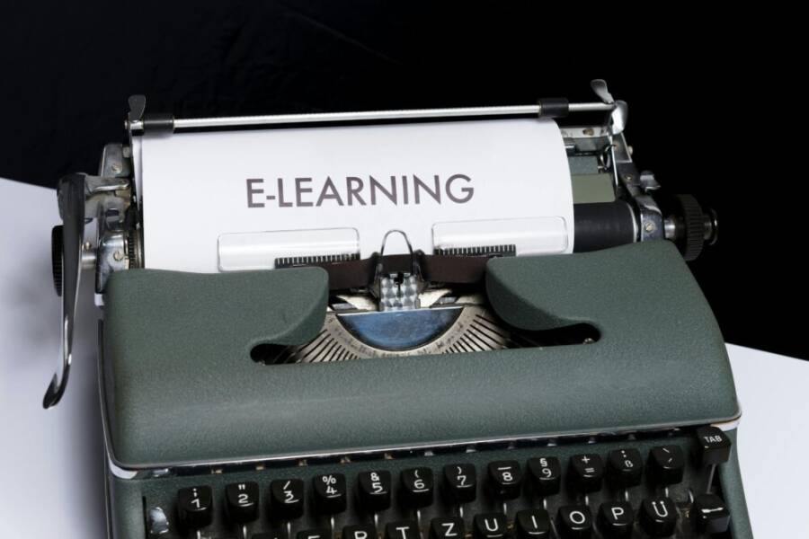 Close-up of a vintage typewriter displaying the concept of e-learning on paper