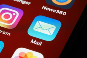 Macro shot of smartphone screen displaying various app icons including Mail and Instagram.