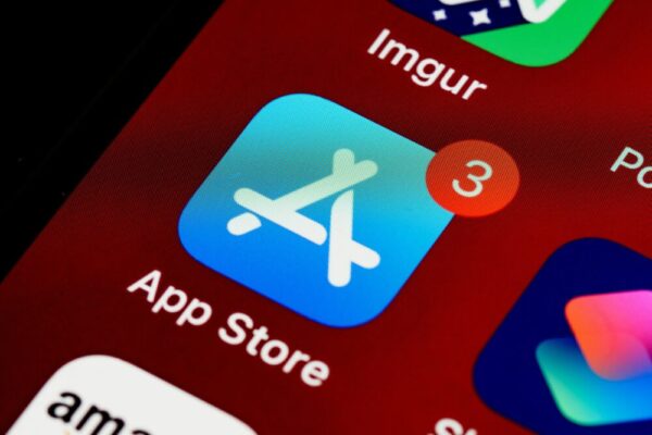 Close-up of App Store icon on iPhone screen with notification badge, highlighting app updates
