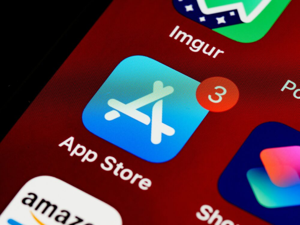 Close-up of App Store icon on iPhone screen with notification badge, highlighting app updates