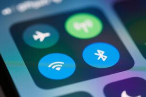 A close-up image showing smartphone control panel with various icons like WiFi and Bluetooth