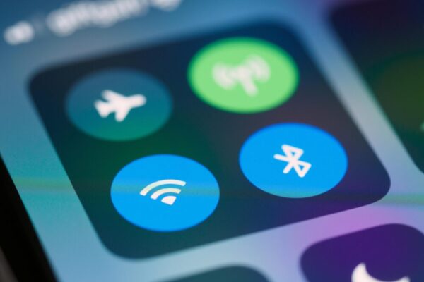 A close-up image showing smartphone control panel with various icons like WiFi and Bluetooth