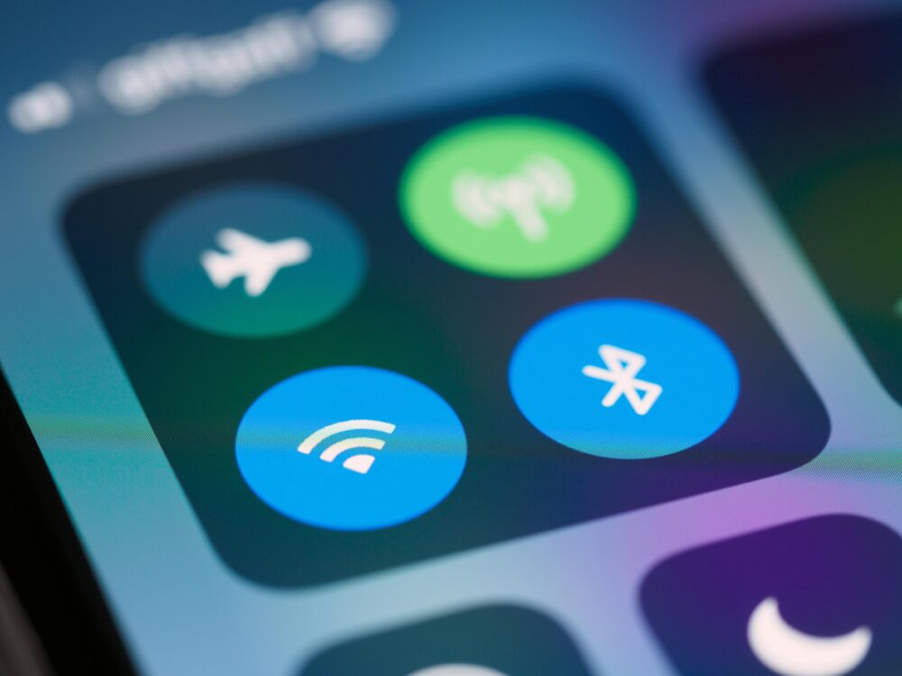 A close-up image showing smartphone control panel with various icons like WiFi and Bluetooth