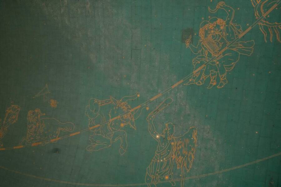 Illustration of zodiac signs on a historic astronomical ceiling, showcasing intricate details and vintage charm.