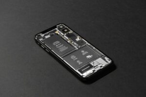 High-resolution image of a smartphone showcasing its internal components on a dark surface.