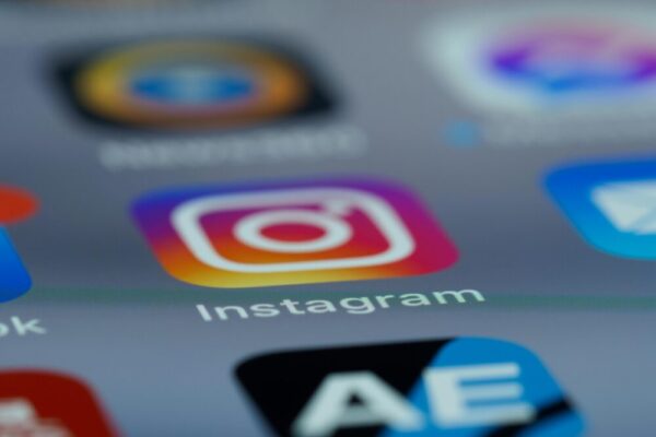 Instagram app icon in focus on a smartphone screen, blurred background.