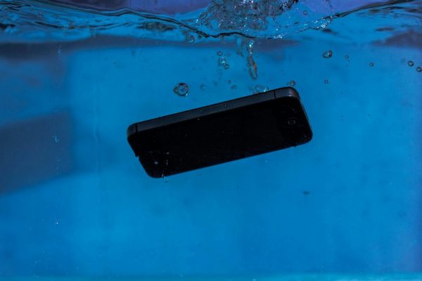 A smartphone captured underwater, illustrating themes of technology and water resistance.