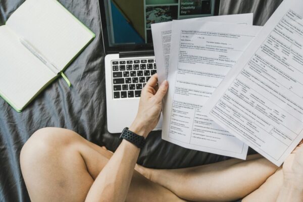 Freelancer managing documents on a laptop from home for productivity