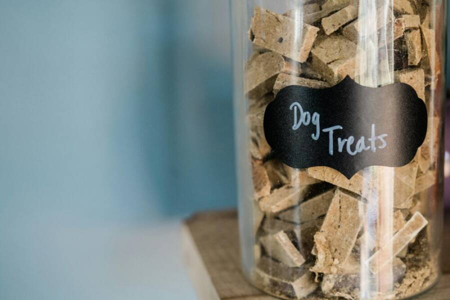 image of dog treats in a glass jar on a wooden surface
