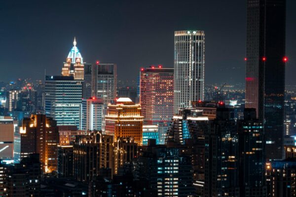 Illuminated Taipei skyline featuring skyscrapers and vibrant city lights at night.