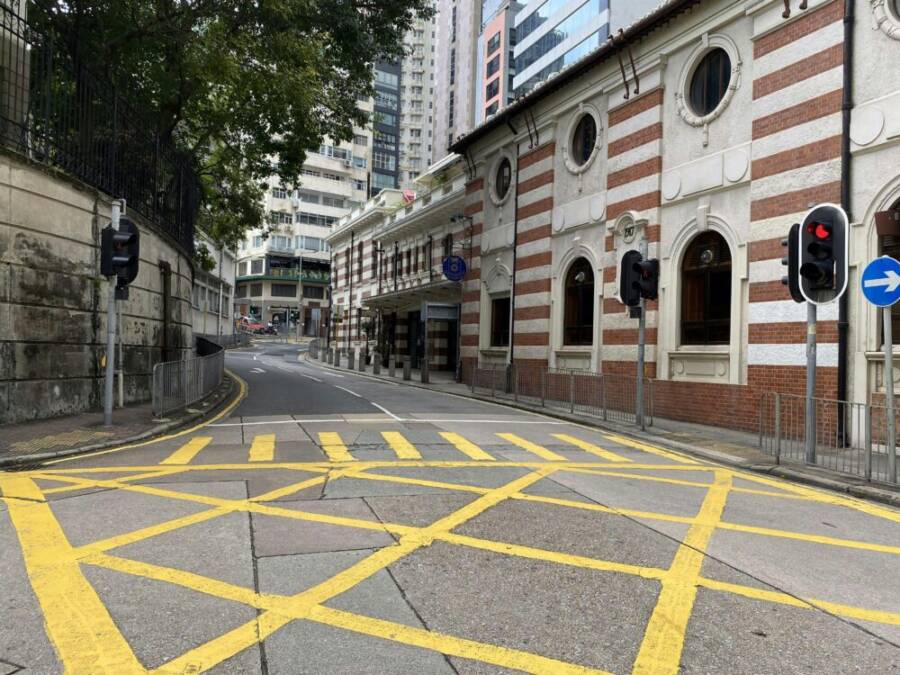 A quiet urban street scene with distinctive architecture in Central Hong Kong Island
