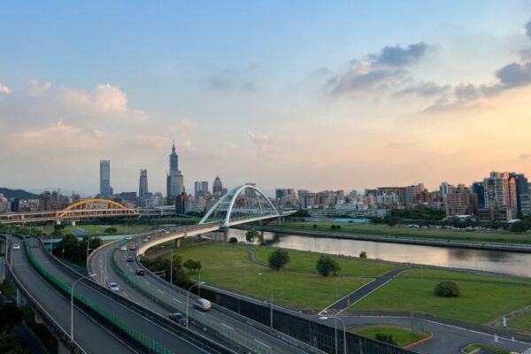 Twilight view of Taipei cityscape with bridges and skyscrapers under a clear sky