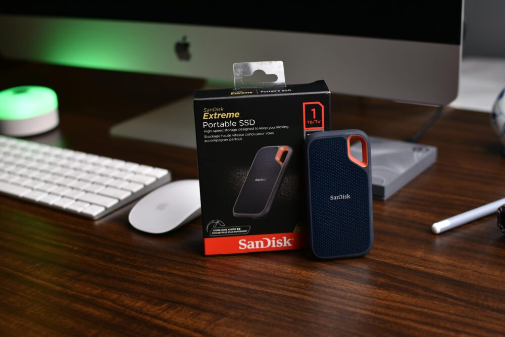 SanDisk Extreme Portable SSD on a modern office desk with iMac setup.