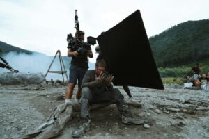 A breathtaking real-life film location in Taiwan, such as a misty mountain valley at dawn with golden natural light filtering through ancient trees