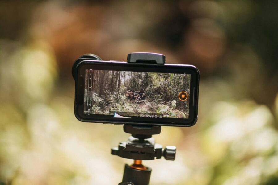 Smartphone mounted on tripod capturing nature. Ideal for vlogging and travel videos.
