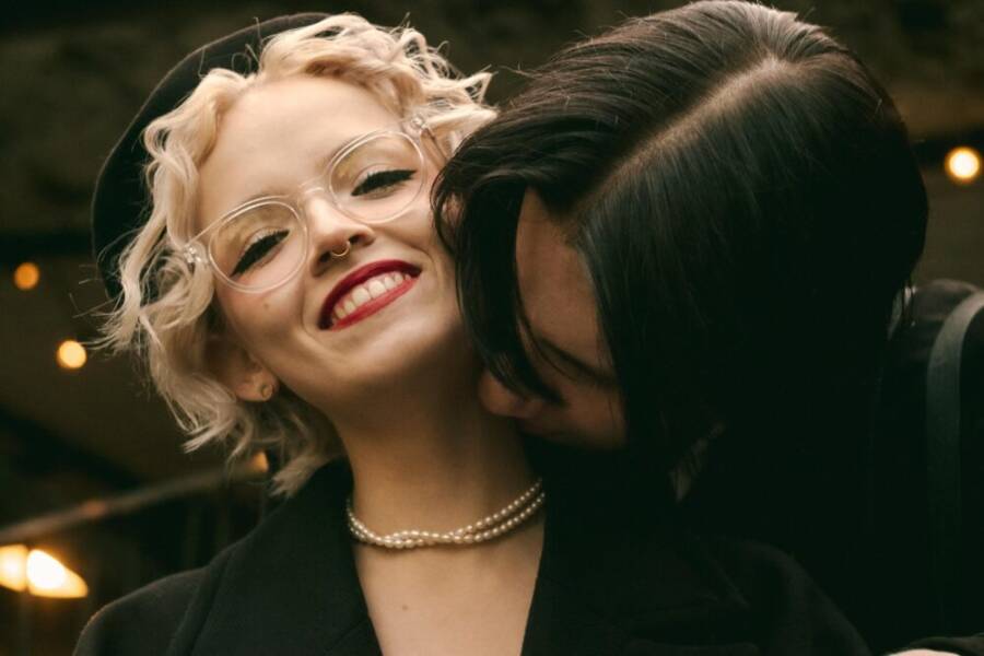 A joyful couple shares a loving embrace outdoors, highlighting happiness and affection
