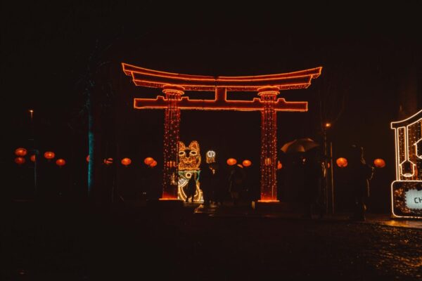 Magical night scene with an illuminated Torii gate and festive lanterns celebrating a cultural festival
