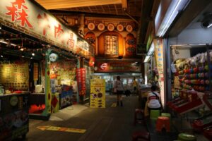 Explore the lively atmosphere of Feng Chia Night Market in Taichung, Taiwan, showcasing colorful stalls and bustling activity.