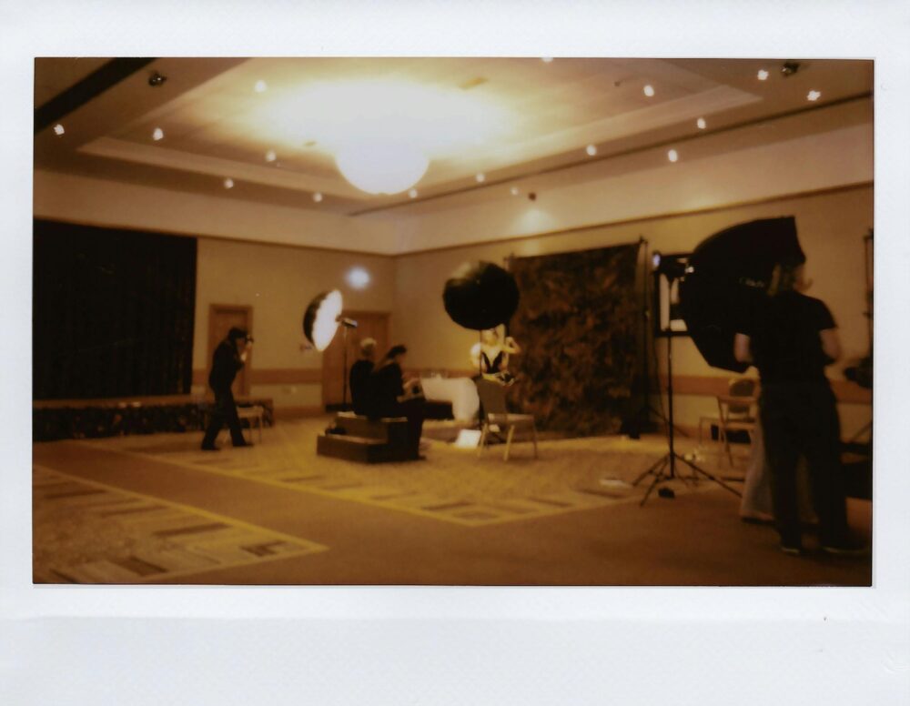 Indoor studio setup with professional lighting and crew at work