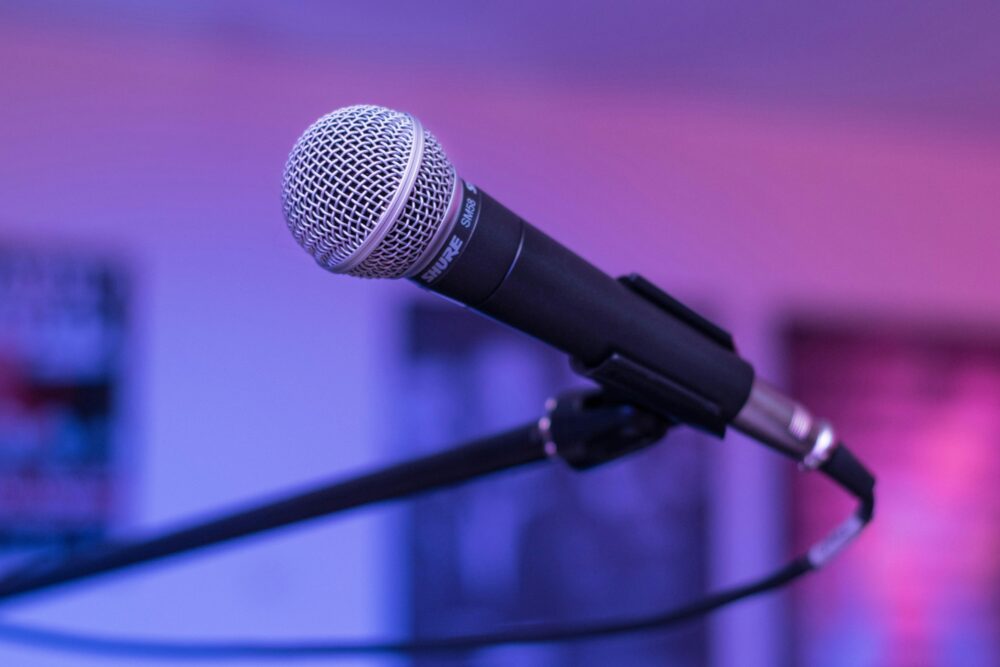 A focused capture of a microphone in a studio environment, ideal for audio-themed projects.