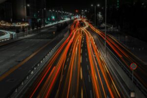 Vibrant city highway at night with dynamic light trails from fast-moving vehicles